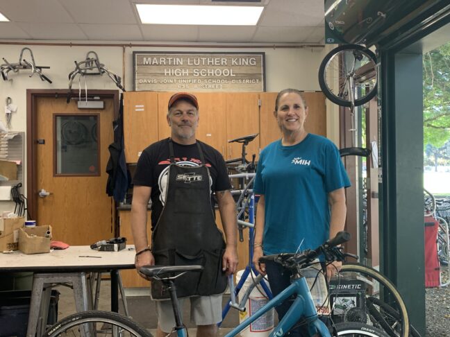 Cathi of Make It Happen stands with Theo from King High School in Davis in their Bicycle Repair Shop