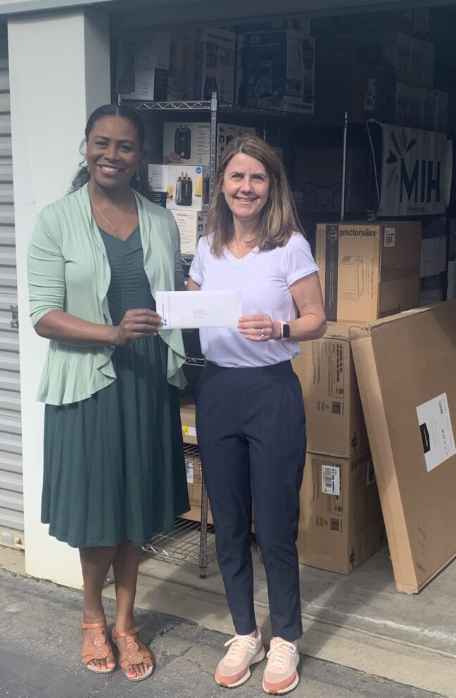 Dr. Allegra Pickett of the Teichert Foundation presents a check to Make It Happen for Yolo County board member Yvonne Emmons