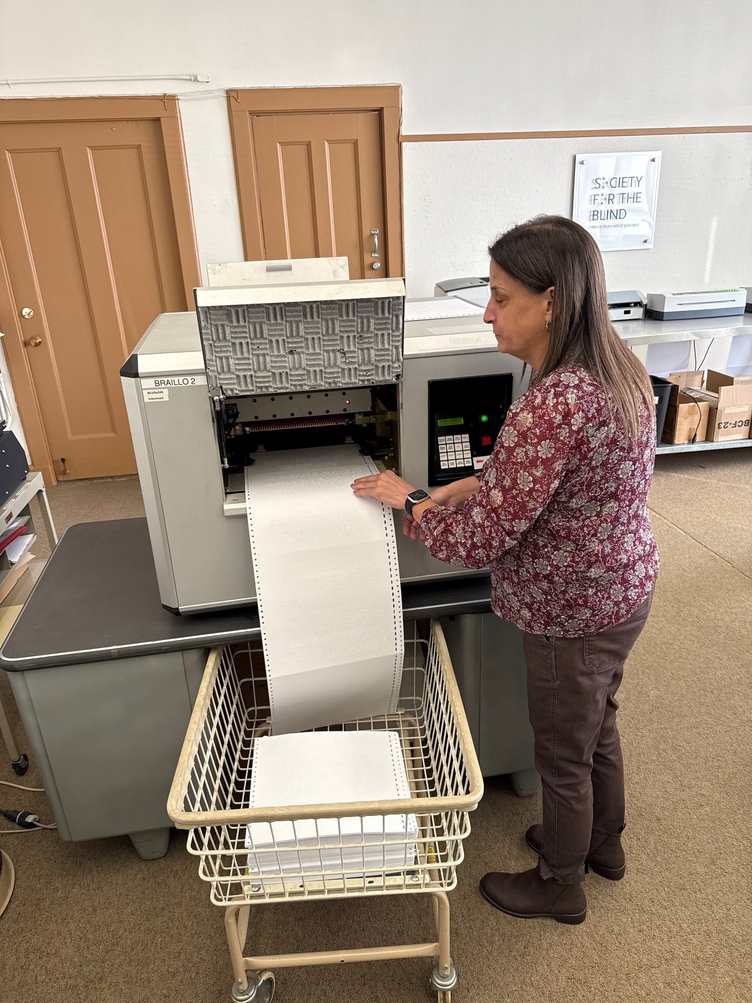 Jill Guilbeau manager of Society for the Blind’s braille production program creates a brailled document using the Braillo2 machine in the Sacramento office